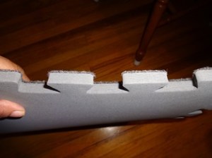 These have carpet-like fabric on top and some dense foam underneath. They are not very thick, but they do absorb impact. 